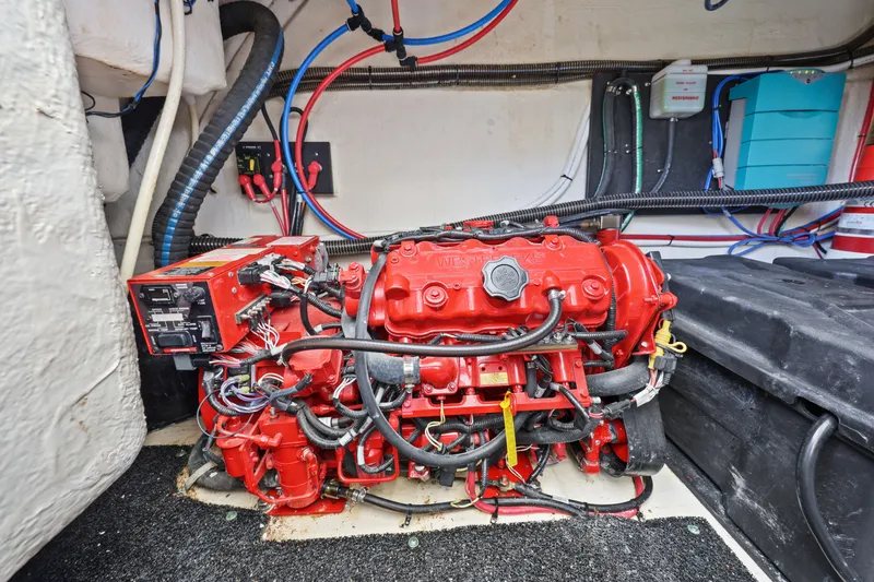 Slide: The Image of Engine compartment of a 2021 Regal 38 XO boat, featuring a red engine and wiring. - 45