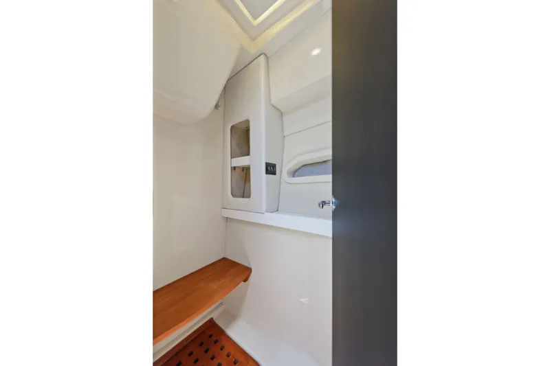 Slide: The Image of 2021 Regal 38 XO interior cabin with wooden bench and storage. - 39