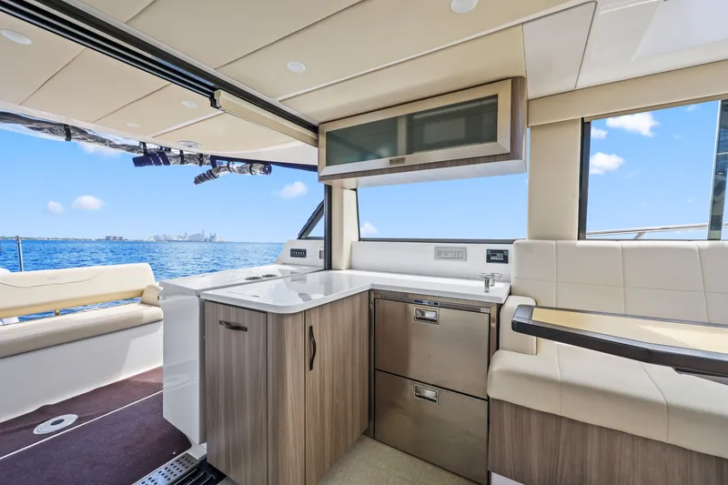 Slide: The Image of Luxurious interior of 2021 Regal 38 XO yacht with modern kitchen and ocean view. - 24