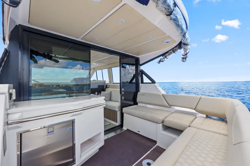 Slide: The Image of Luxurious 2021 Regal 38 XO yacht interior with plush seating and ocean view. - 14