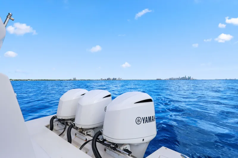 Slide: The Image of 2021 Regal 38 XO boat with Yamaha engines on open blue sea. - 44