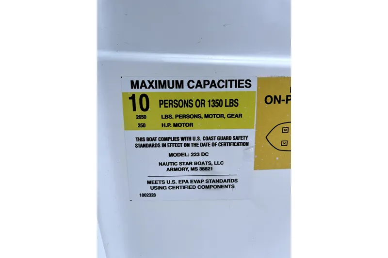 Slide: The Image of 2025 NauticStar 223 DC Deck boat capacity label, max 10 persons or 1350 lbs, 250 HP motor. - 10