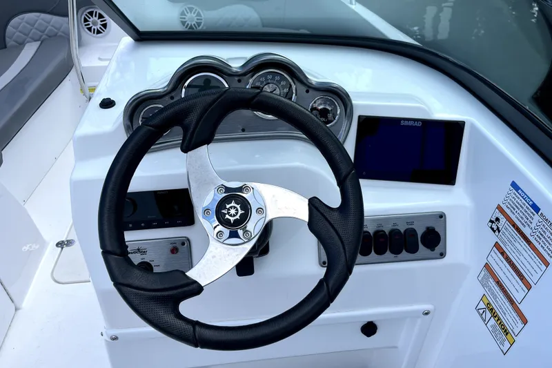 Slide: The Image of Steering console of 2025 NauticStar 223 DC Deck boat with gauges and controls. - 5