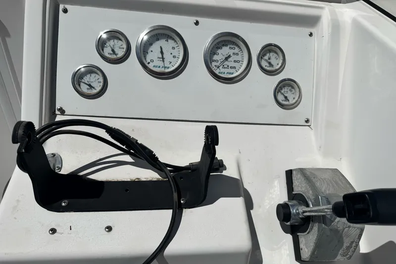 Slide: The Image of Dashboard of a 2003 Seapro 190 WA boat with gauges and controls. - 15