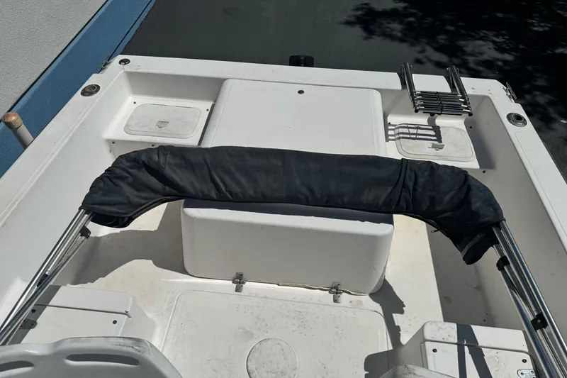 Slide: The Image of 2003 Seapro 190 WA boat interior with seating and storage compartments. - 19