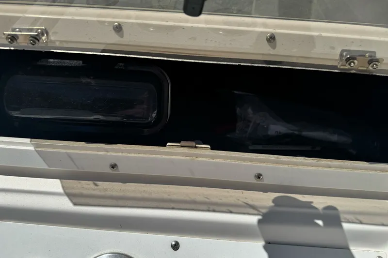 Slide: The Image of Open storage compartment on 2003 Seapro 190 WA boat, showing interior details. - 14