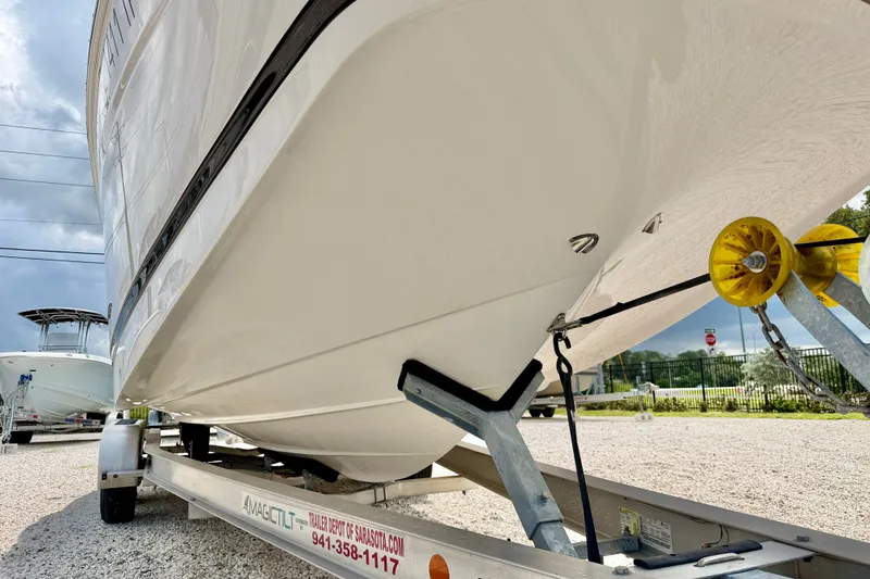 Slide: The Image of 2023 Four Winns HD8 OB boat on trailer, showcasing sleek hull design. - 36