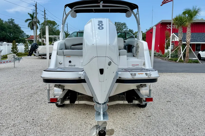 Slide: The Image of 2023 Four Winns HD8 OB boat with powerful outboard motor, displayed outdoors. - 6