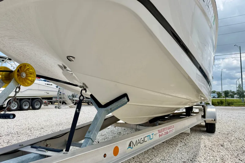 Slide: The Image of 2023 Four Winns HD8 OB boat on trailer, parked on gravel lot. - 37