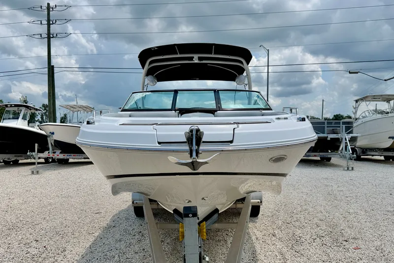 Slide: The Image of 2023 Four Winns HD8 OB boat on trailer under cloudy sky. - 2