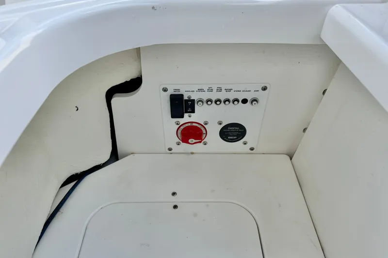Slide: The Image of Control panel of 2023 Four Winns HD8 OB boat, featuring switches and a digital display. - 29