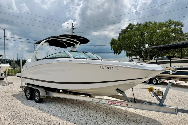 Slide: The Image of 2023 Four Winns HD8 OB boat on trailer under cloudy sky. - 3