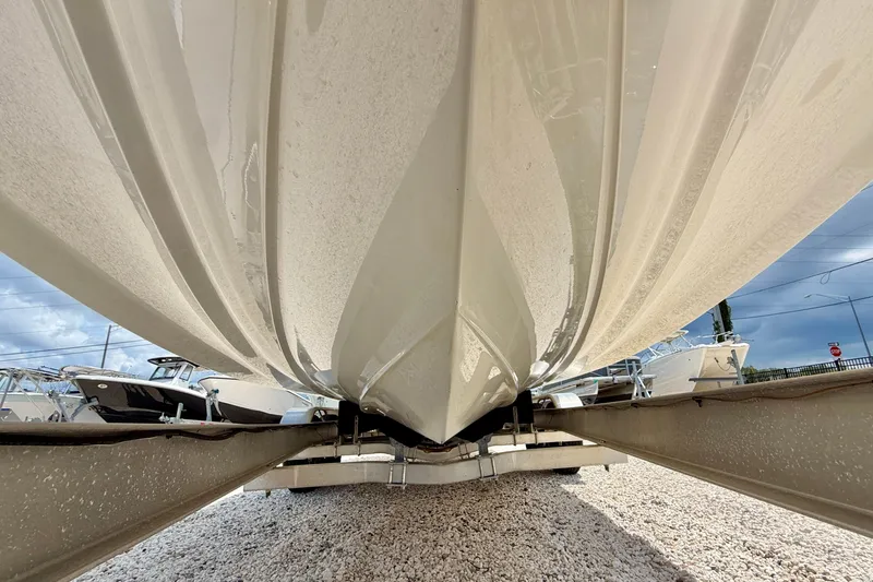 Slide: The Image of Underneath view of a 2023 Four Winns HD8 OB boat on a trailer. - 35