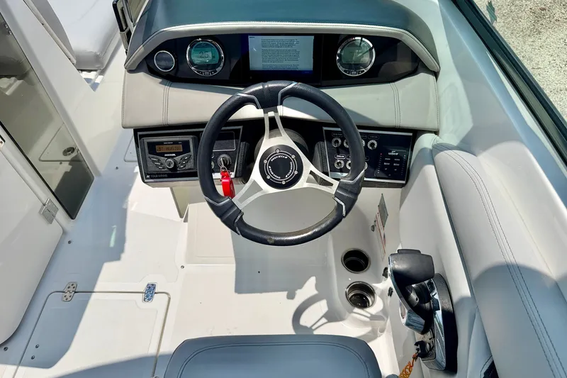 Slide: The Image of 2023 Four Winns HD8 OB boat cockpit with steering wheel and control panel. - 13