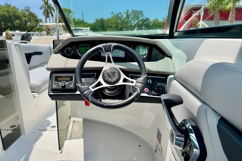 Slide: The Image of 2023 Four Winns HD8 OB boat cockpit with steering wheel and control panel. - 14