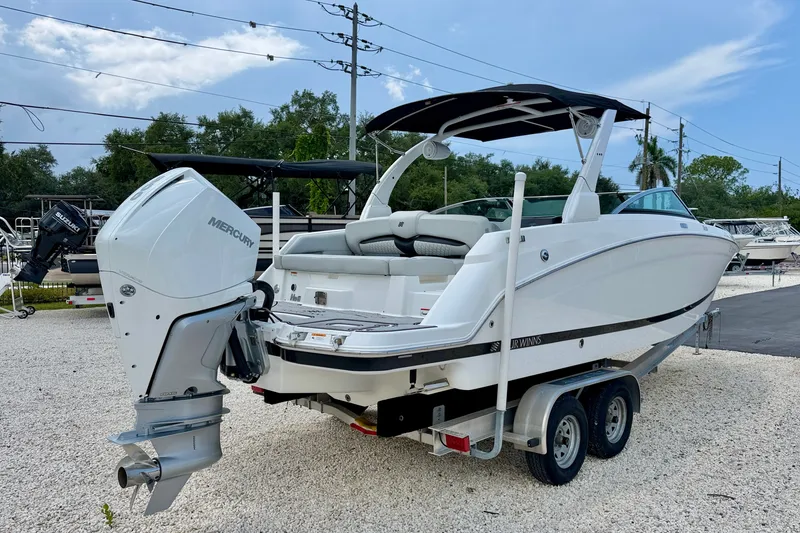 Slide: The Image of 2023 Four Winns HD8 OB boat with Mercury outboard engine on a trailer. - 7