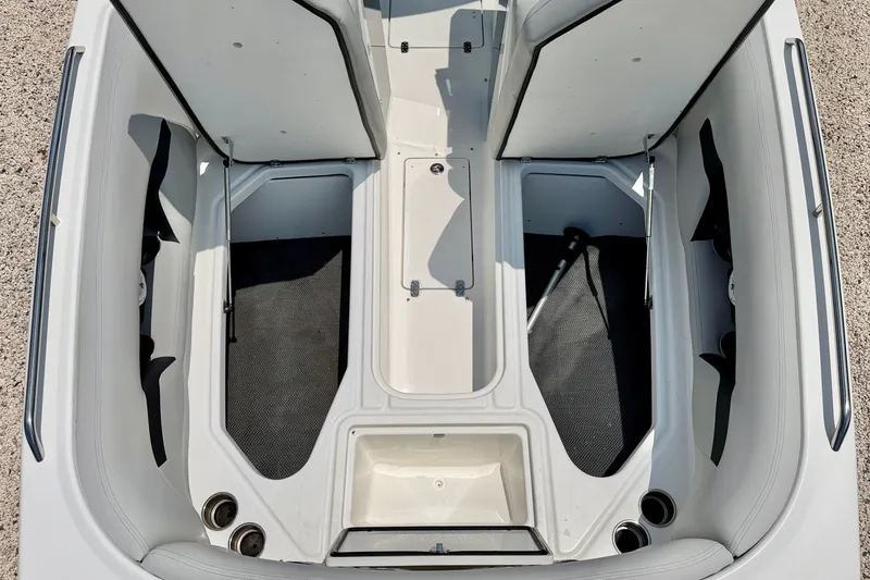 Slide: The Image of 2023 Four Winns HD8 OB boat interior with open storage compartments and seating. - 27