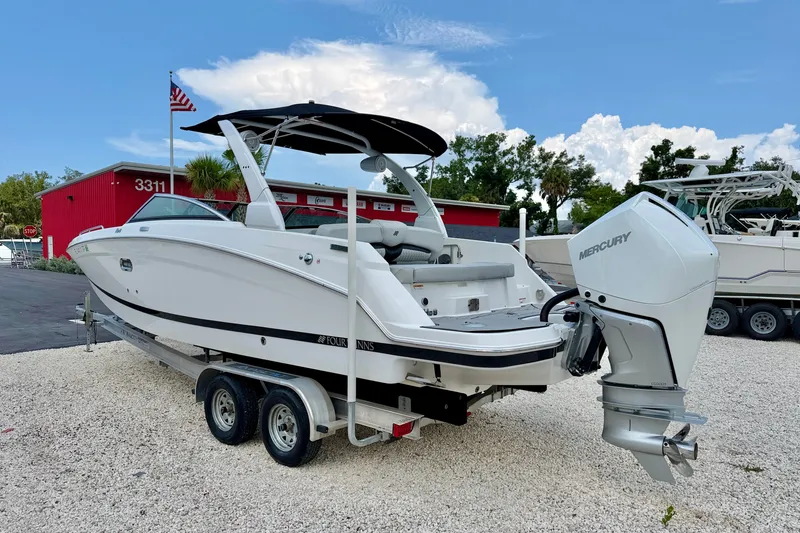 Slide: The Image of 2023 Four Winns HD8 OB boat with Mercury outboard motor on a trailer. - 5