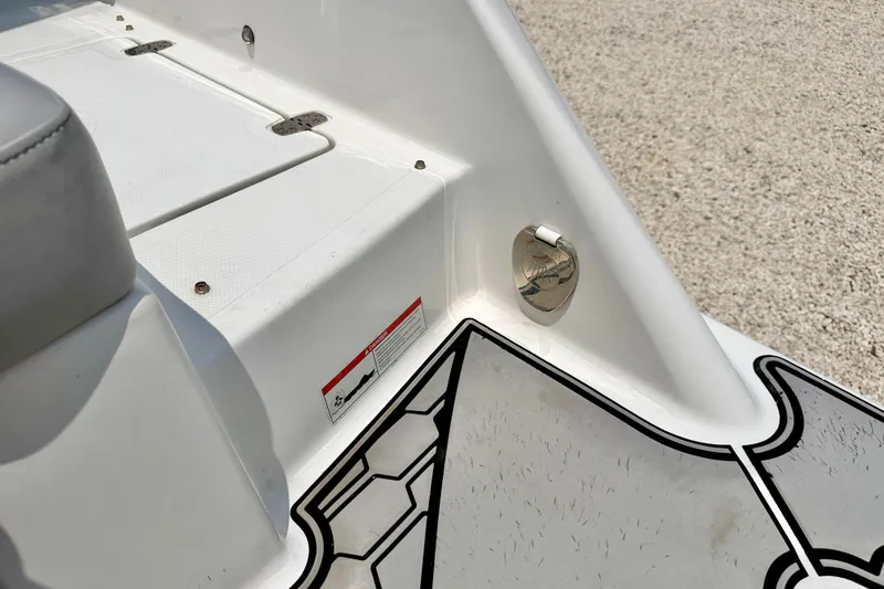 Slide: The Image of 2023 Four Winns HD8 OB boat interior detail with textured flooring and metal fixture. - 32