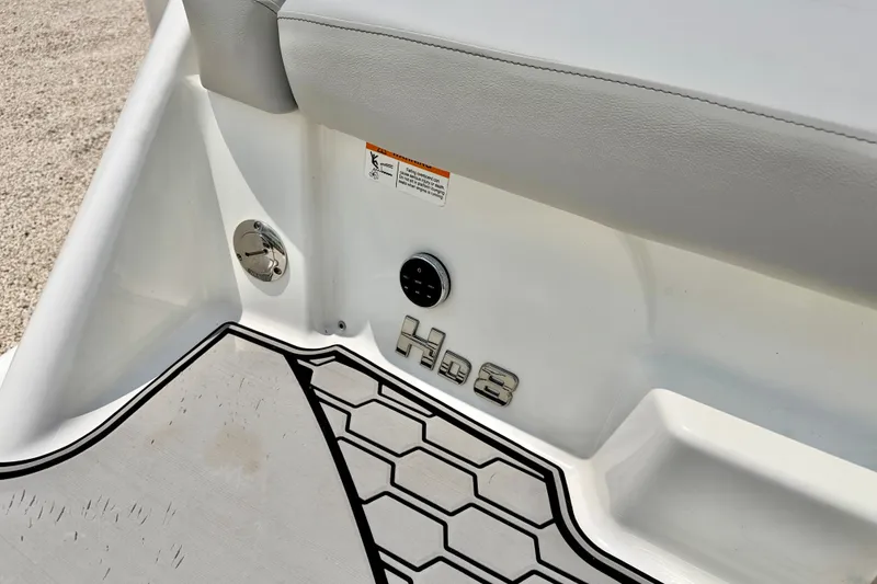 Slide: The Image of 2023 Four Winns HD8 OB boat interior detail with logo and textured flooring. - 34