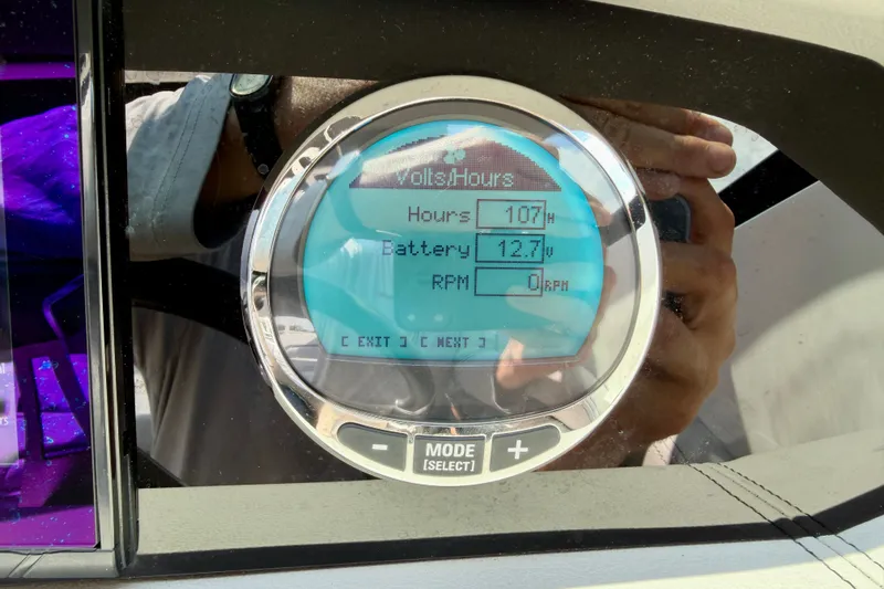Slide: The Image of Digital display on 2023 Four Winns HD8 OB showing hours, battery, and RPM. - 16