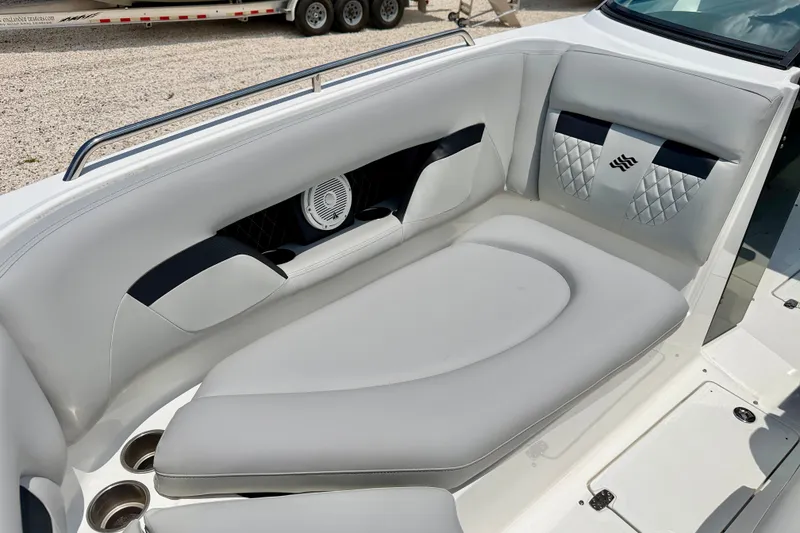 Slide: The Image of 2023 Four Winns HD8 OB boat interior with cushioned seating and cup holders. - 10