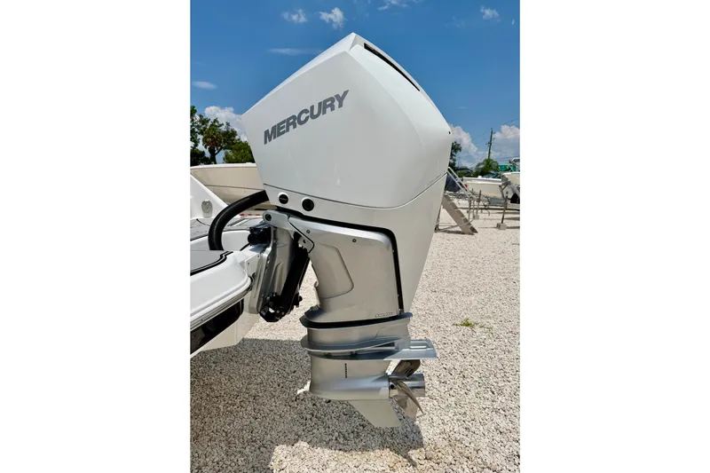 Slide: The Image of 2023 Four Winns HD8 OB with Mercury outboard motor on gravel surface. - 40