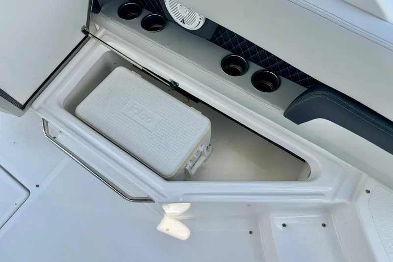 Slide: The Image of 2023 Four Winns HD8 OB boat interior with Igloo cooler and cup holders. - 22