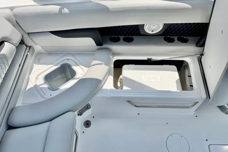 Slide: The Image of 2023 Four Winns HD8 OB boat interior with storage compartments and cooler. - 23