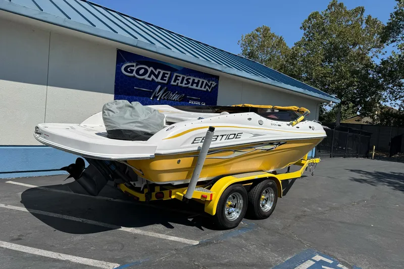 Slide: The Image of 2006 Ebbtide 2100 Bow Rider boat on trailer outside marine shop. - 2