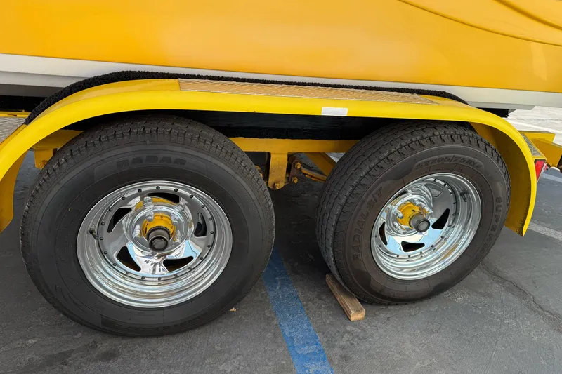 Slide: The Image of Yellow Ebbtide 2100 Bow Rider trailer with dual chrome wheels, 2006 model. - 7