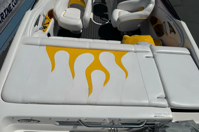 Slide: The Image of 2006 Ebbtide 2100 Bow Rider boat interior with white and yellow flame-patterned seating. - 9