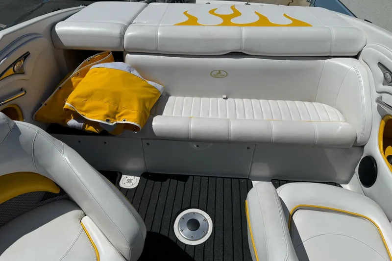 Slide: The Image of 2006 Ebbtide 2100 Bow Rider interior with white seats and yellow accents. - 18