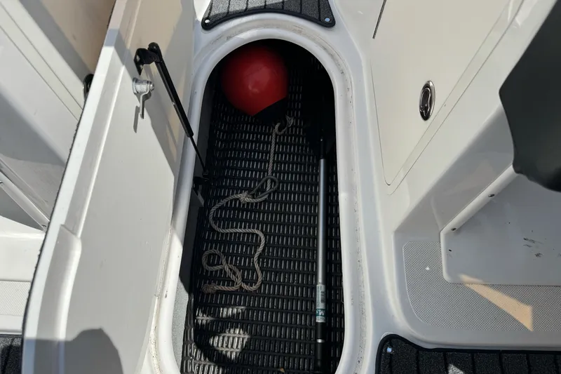 Slide: The Image of Storage compartment of 2006 Ebbtide 2100 Bow Rider with rope and red buoy. - 24