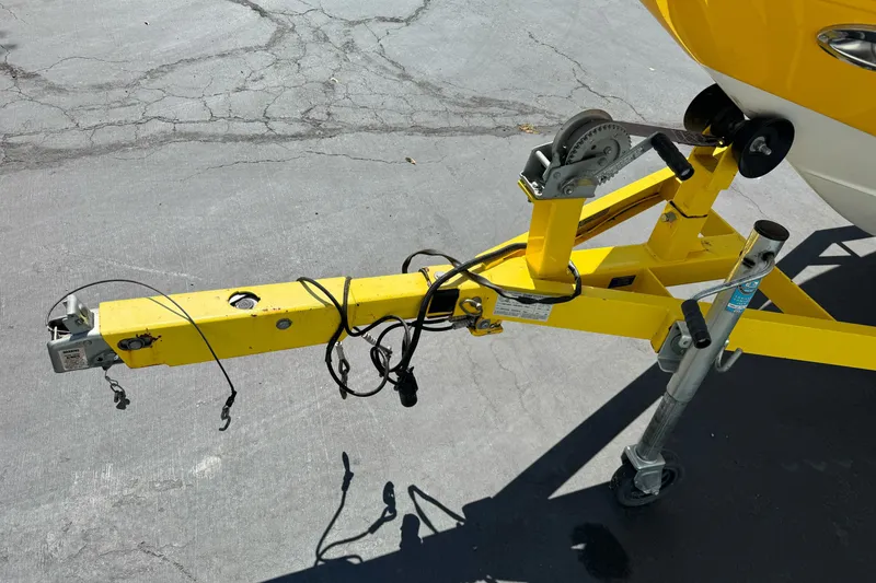 Slide: The Image of Yellow trailer hitch of 2006 Ebbtide 2100 Bow Rider on pavement. - 6