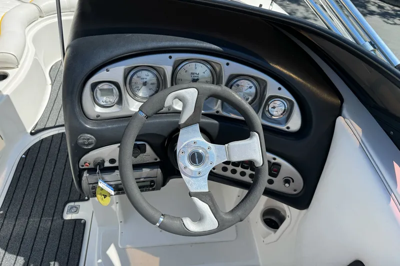 Slide: The Image of 2006 Ebbtide 2100 Bow Rider dashboard with steering wheel and gauges. - 14