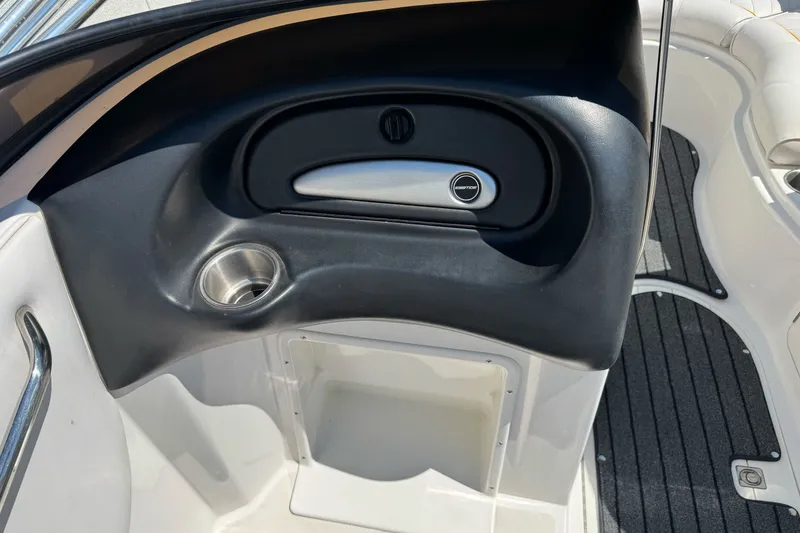 Slide: The Image of Interior of 2006 Ebbtide 2100 Bow Rider boat, featuring a sleek dashboard and cup holder. - 17