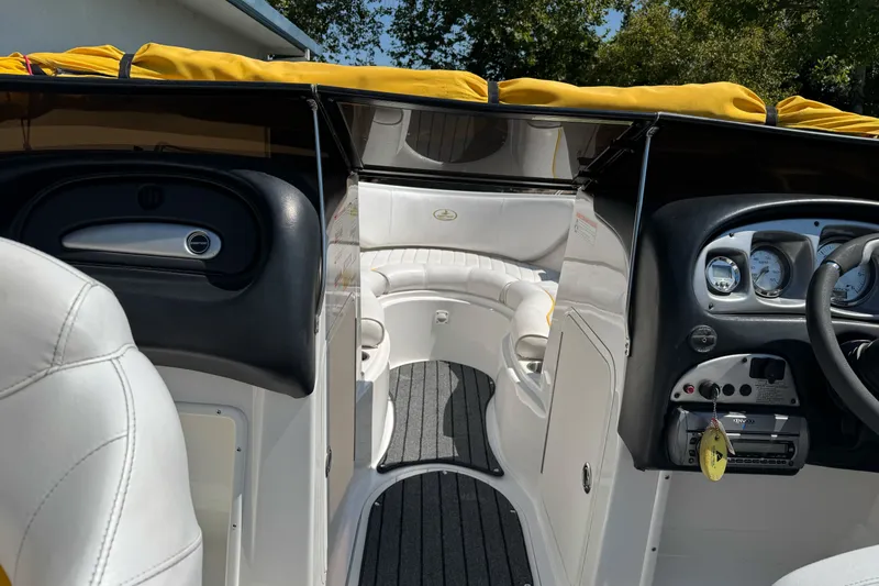 Slide: The Image of Interior view of a 2006 Ebbtide 2100 Bow Rider boat with white seating and dashboard. - 12