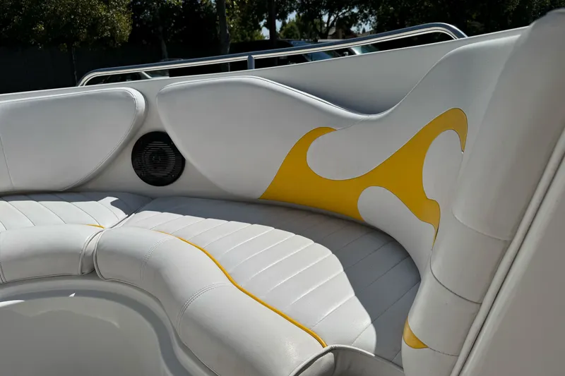 Slide: The Image of 2006 Ebbtide 2100 Bow Rider interior with white and yellow seating, featuring a speaker. - 26