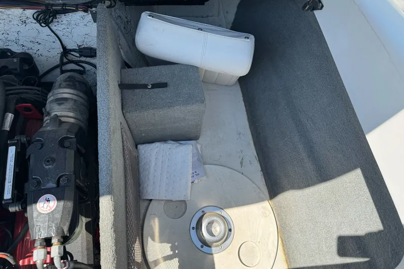 Slide: The Image of Interior view of a 2006 Ebbtide 2100 Bow Rider boat showing engine compartment details. - 20