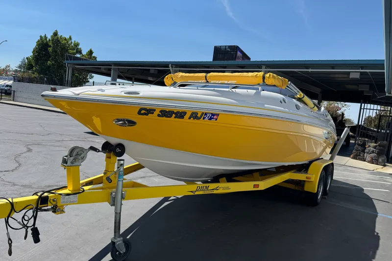 Slide: The Image of Yellow 2006 Ebbtide 2100 Bow Rider boat on trailer in parking lot. - 5