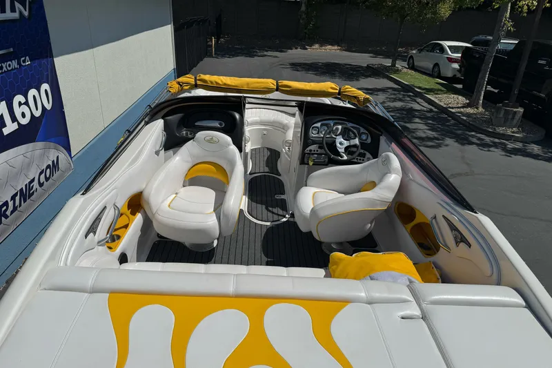 Slide: The Image of 2006 Ebbtide 2100 Bow Rider boat interior with white and yellow seating. - 10
