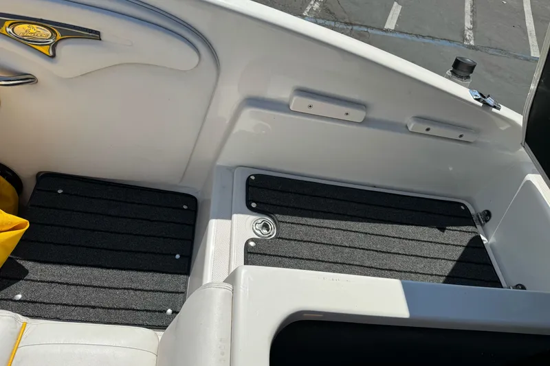 Slide: The Image of Interior view of a 2006 Ebbtide 2100 Bow Rider boat, featuring seating and flooring. - 21