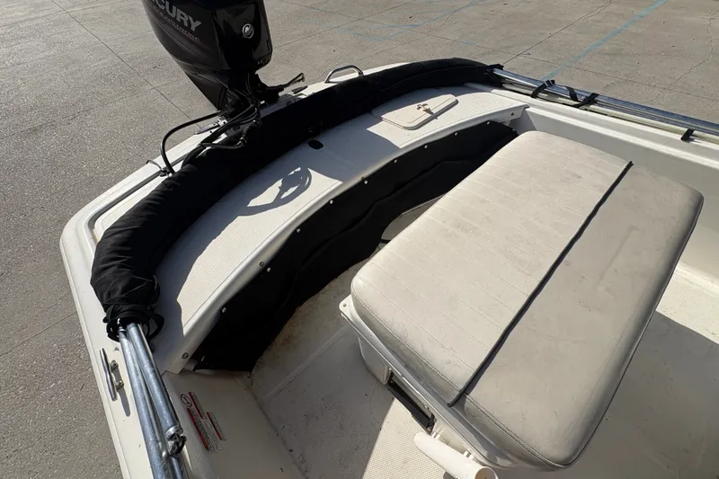 Slide: The Image of 2016 Mako Pro Skiff 17 CC boat interior with Mercury outboard motor. - 17