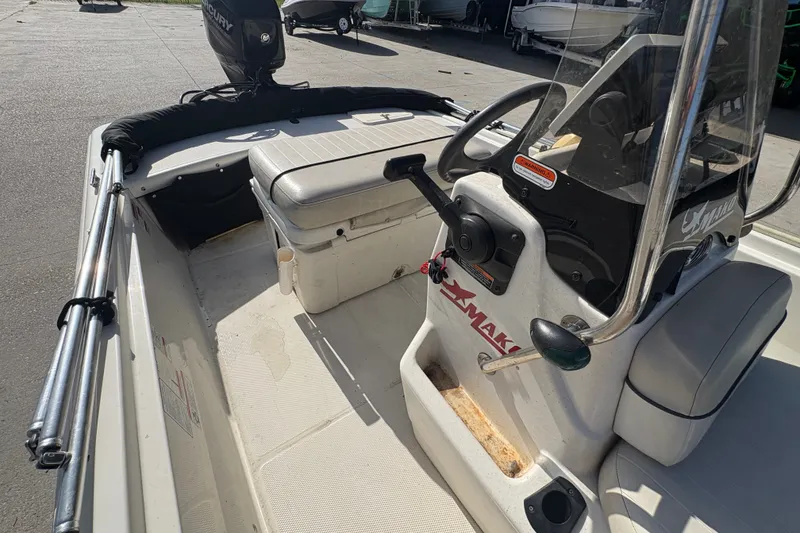 Slide: The Image of 2016 Mako Pro Skiff 17 CC boat interior with steering console and seating. - 14