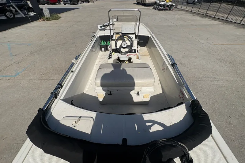 Slide: The Image of 2016 Mako Pro Skiff 17 CC boat interior with steering console and seating. - 18