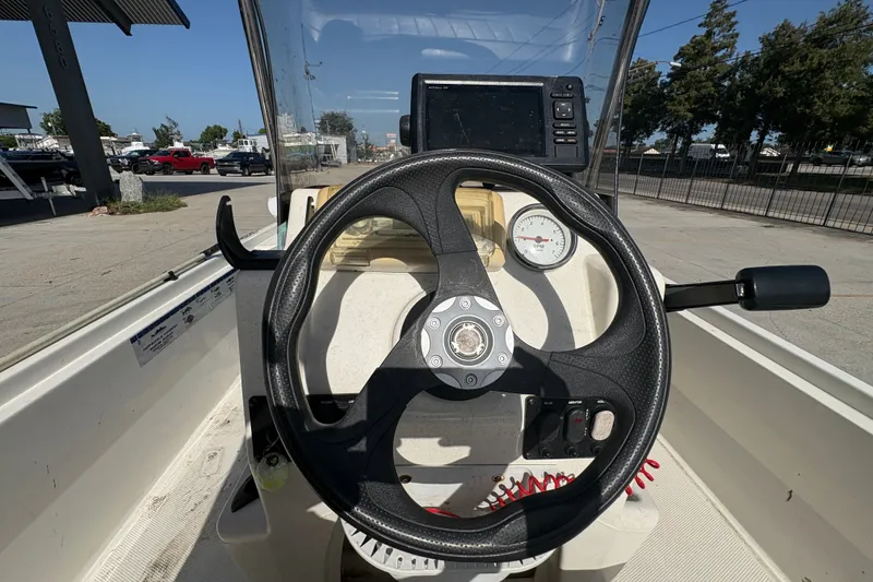Slide: The Image of 2016 Mako Pro Skiff 17 CC boat console with steering wheel and gauges. - 20