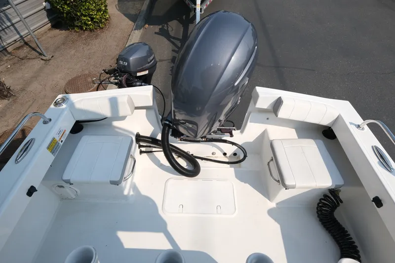 Slide: The Image of 2024 Parker 2100 Center Console boat interior with seating and outboard motor. - 13