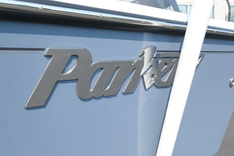 Slide: The Image of 2024 Parker 2100 Center Console boat logo on blue hull. - 6