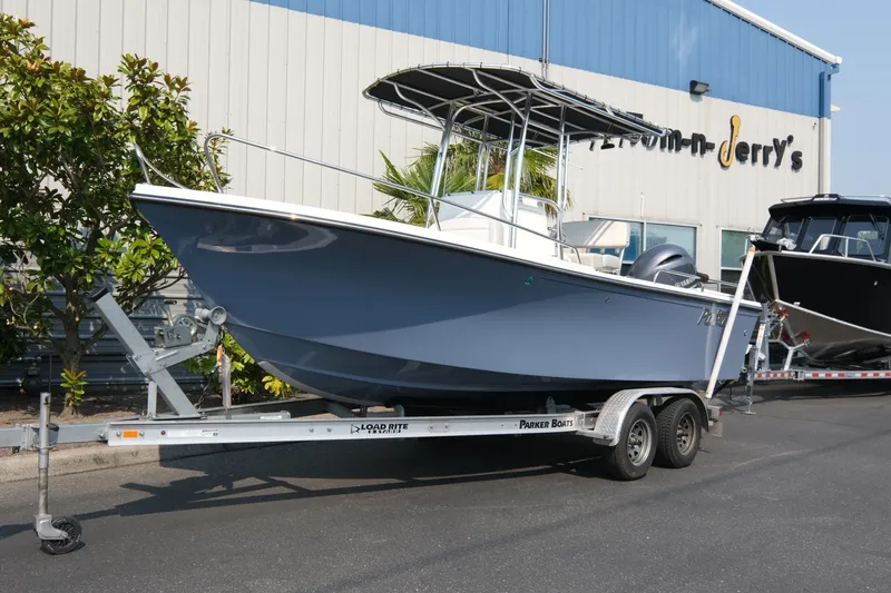 The Image of 2024 Parker 2100 Center Console boat on trailer outside dealership. - 1